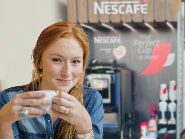 Nescafe in hand of woman