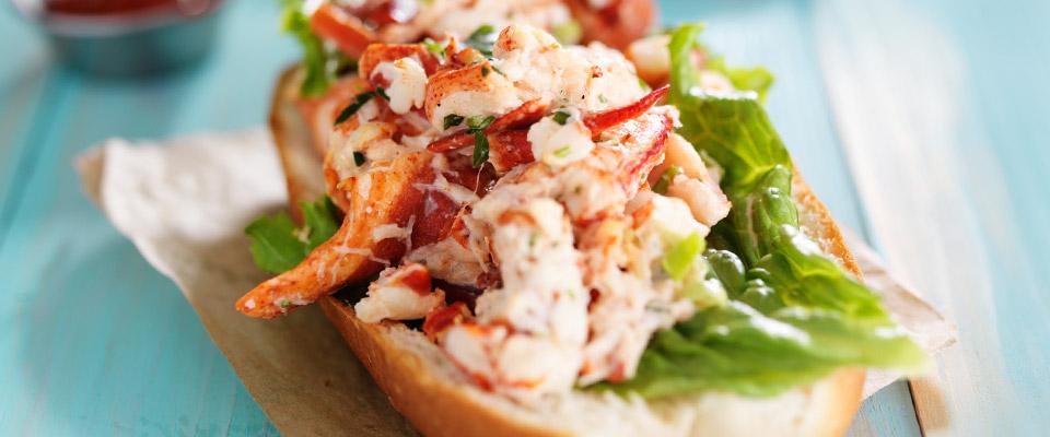 Lobster roll on napkin and wood tabletop