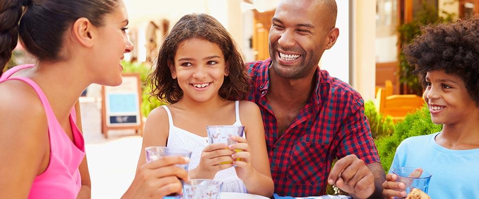 Family eating meal together at outdoor restaurant