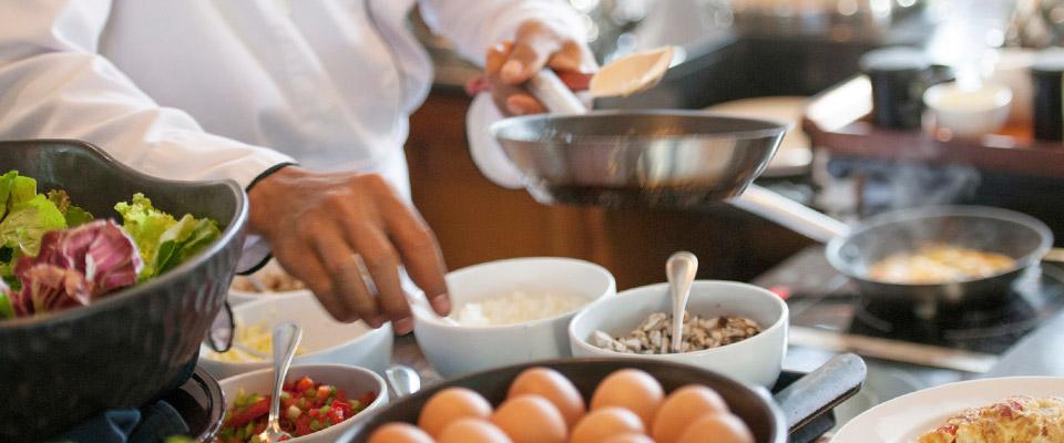 Chef preparing dish at an action station