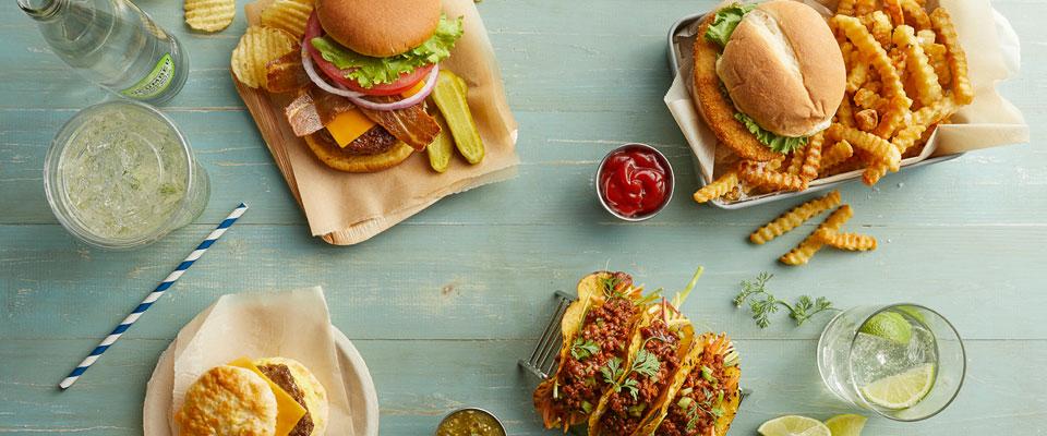 Vegan burger and tacos with drinks photographed overhead