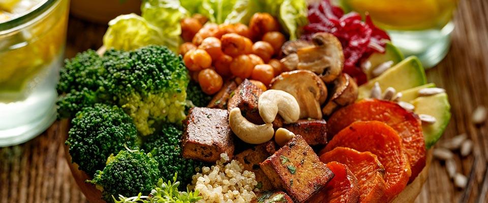 Beverages and bowl with mixed vegetables and nuts