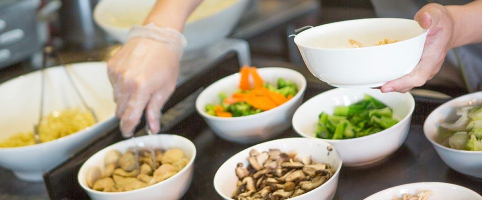 Person making selections at a food bar