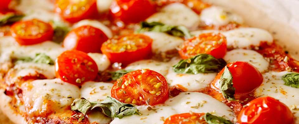 Pizza with tomatoes and basil