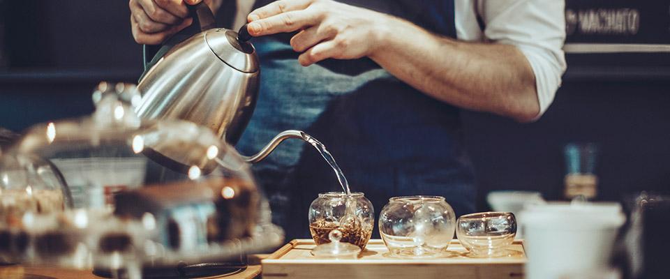 Beverage shop employee making tea