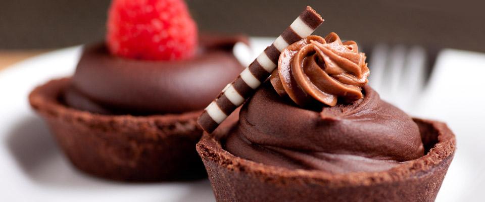 Plate of raspberry and mousse chocolate tarts