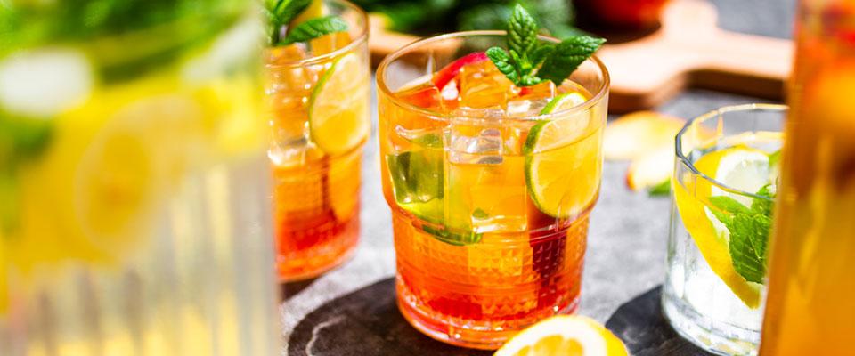 iced teas and lemonade in glasses on table
