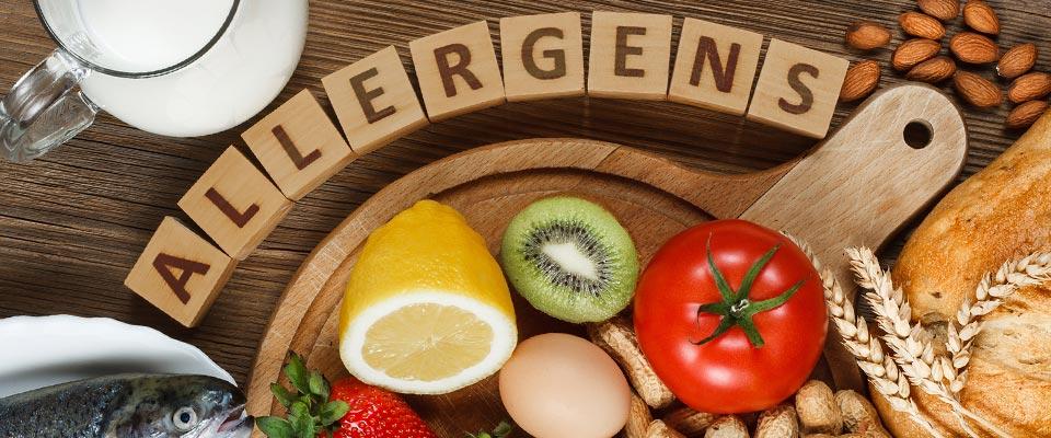 Assorted food allergens on wooden table