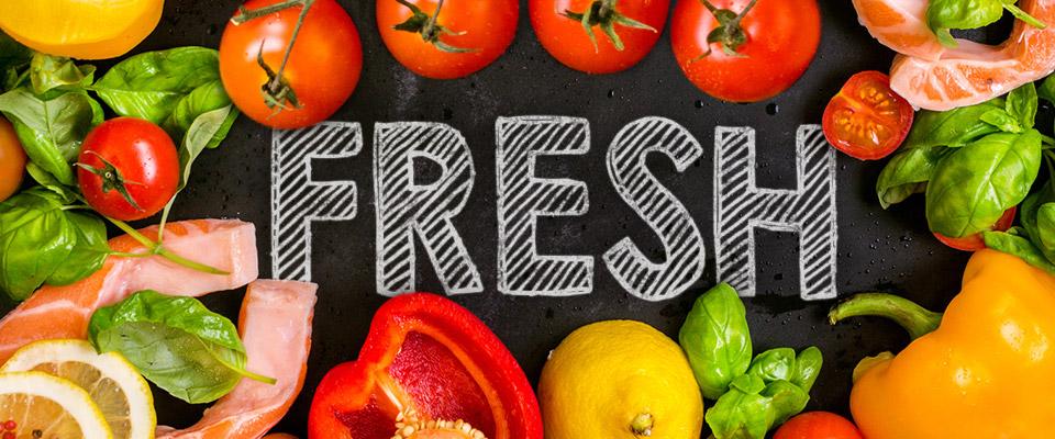 Fresh produce and meat with ‘Fresh’ written on chalkboard surface