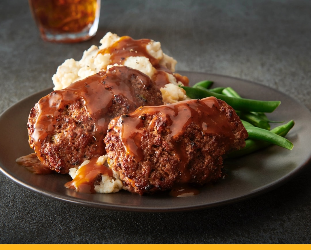 Meatloaf on a plate with mashed potatoes