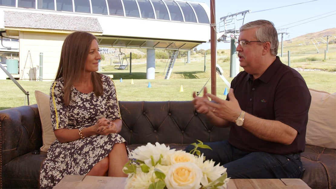 Perry and Fleur sit side by side talking