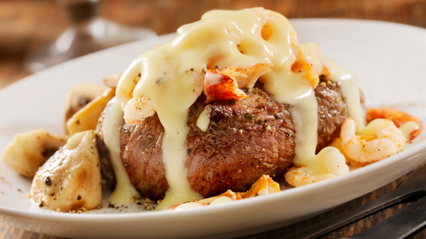 steak topped with sauce on plate