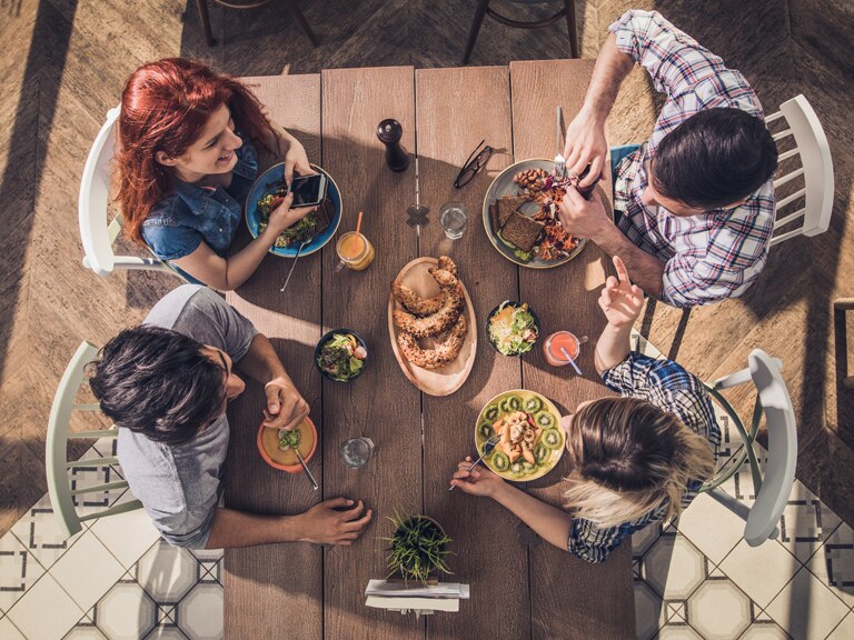 Overhead view of people at table eating