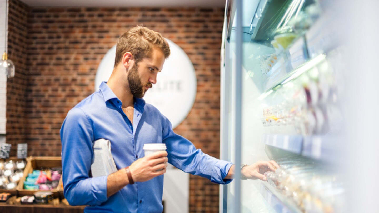 Man grabbing food from a shelf