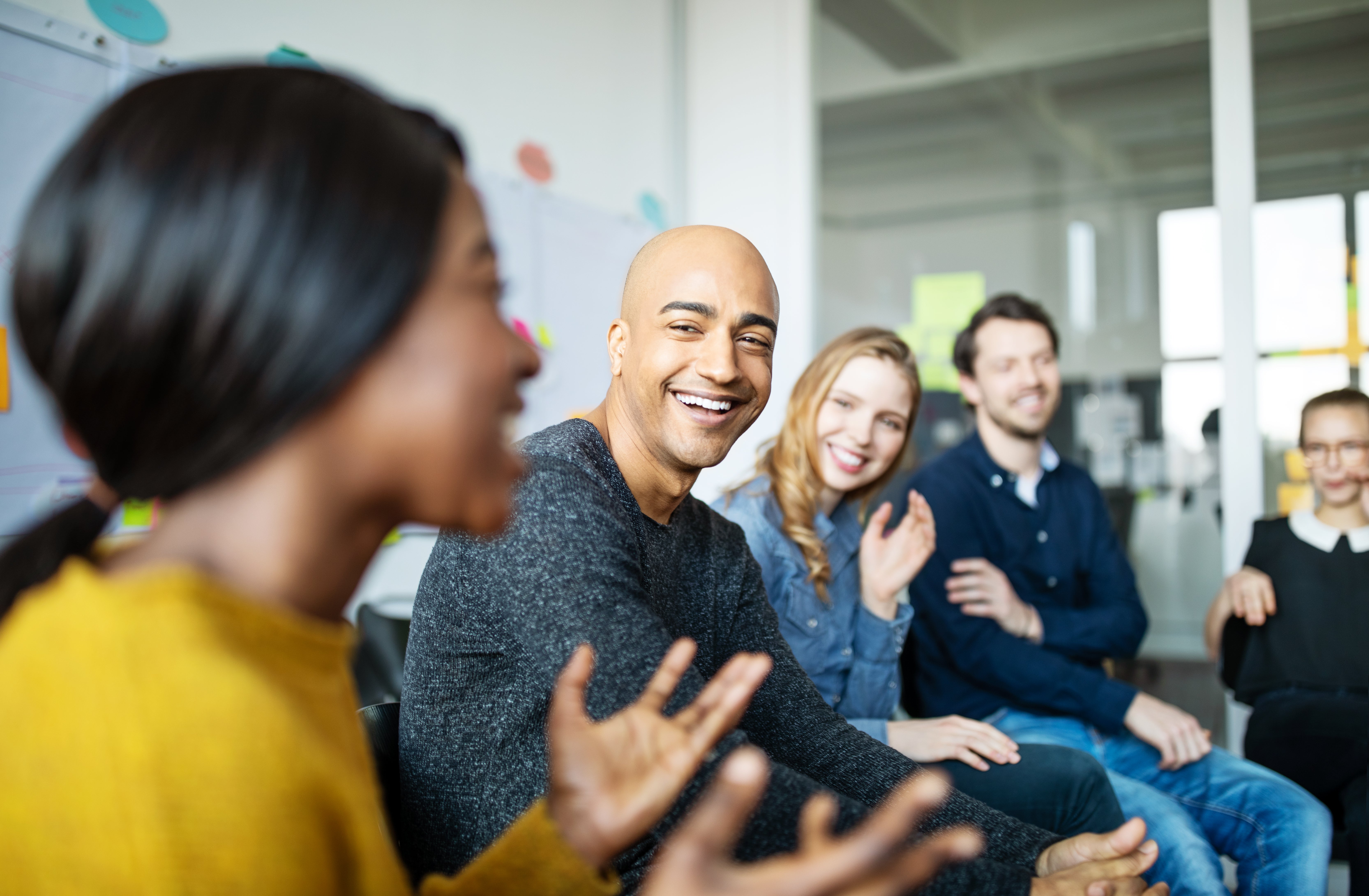 Diverse group of 5 people talking