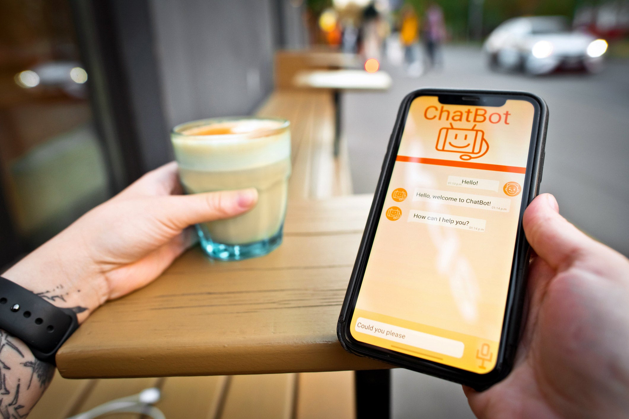 holding a cell phone and cup of coffee