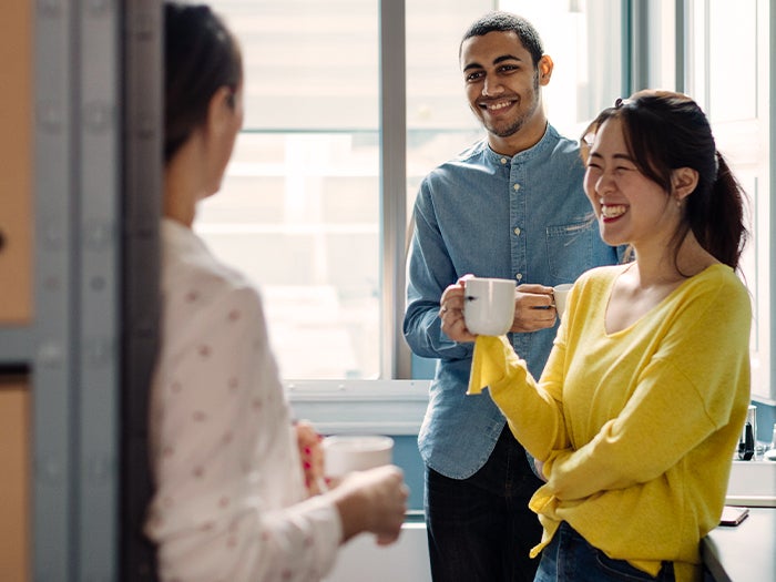 employees enjoying bulk creamer, hot coffee in corporate office