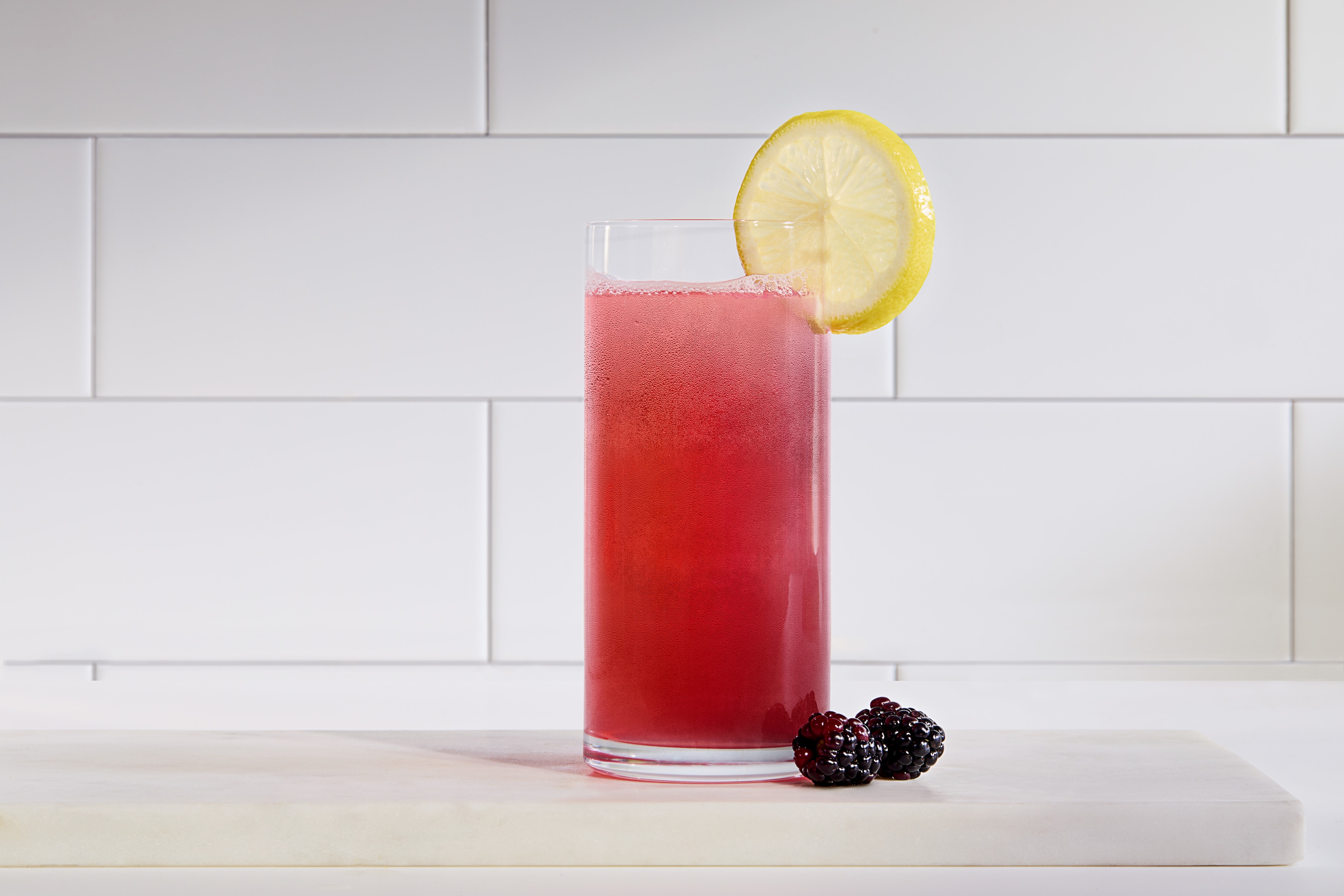 Vitality Blackberry Hibiscus in clear glass with garnish