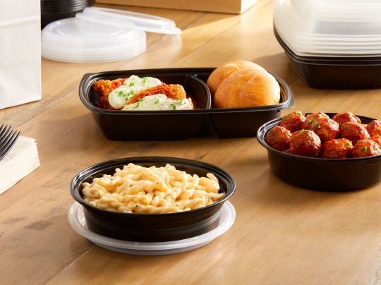 parmesan black pepper pasta on a table with other side dishes