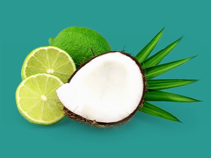 A close-up image of a coconut with multiple lime slices arranged around it