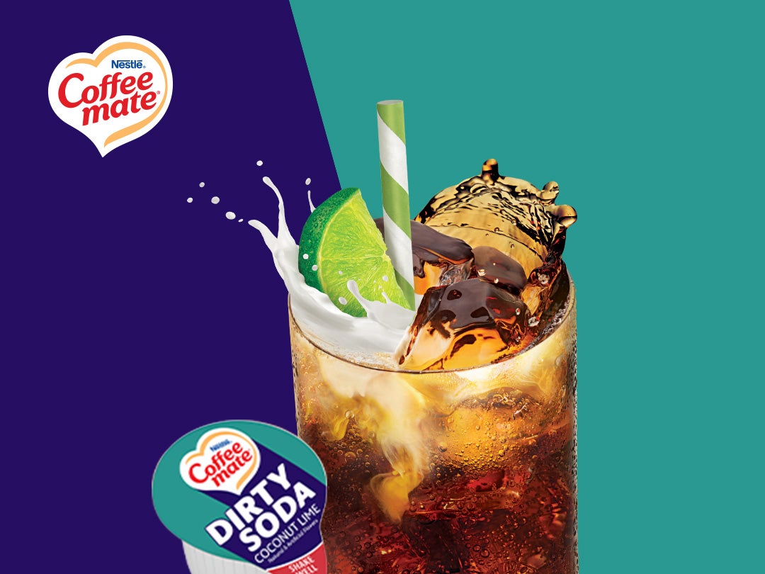 steaming iced coffee with coffee mate dirty soda creamer on a rustic rock surface, creating a cozy and earthy ambiance