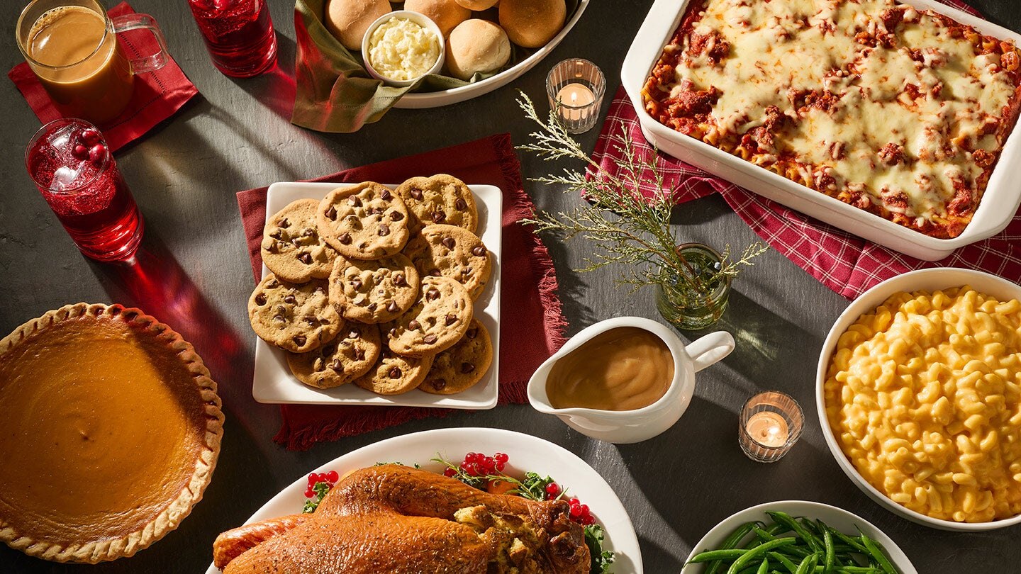 table set with turkey chocolate chip cookies pie and macaroni and cheese
