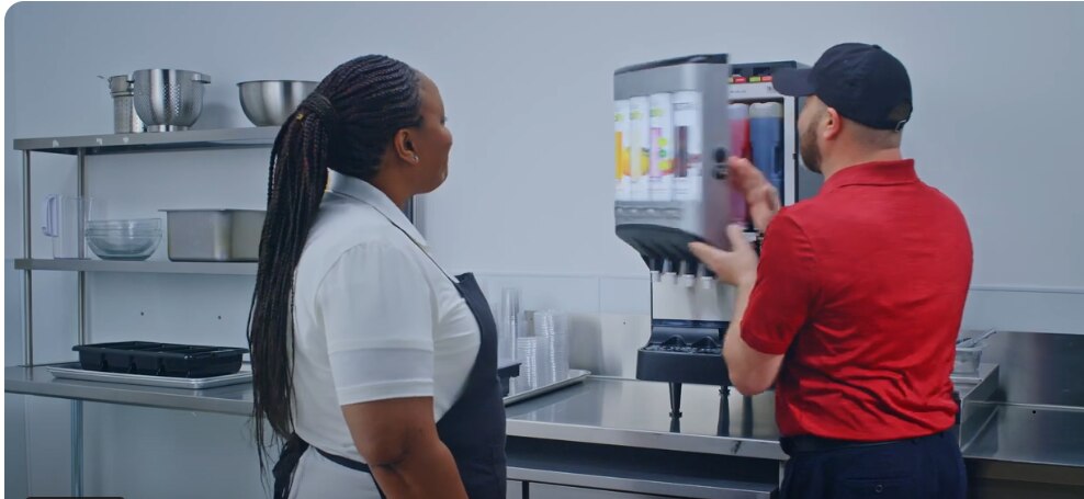 woman and man standing in front of vitality express equipment
