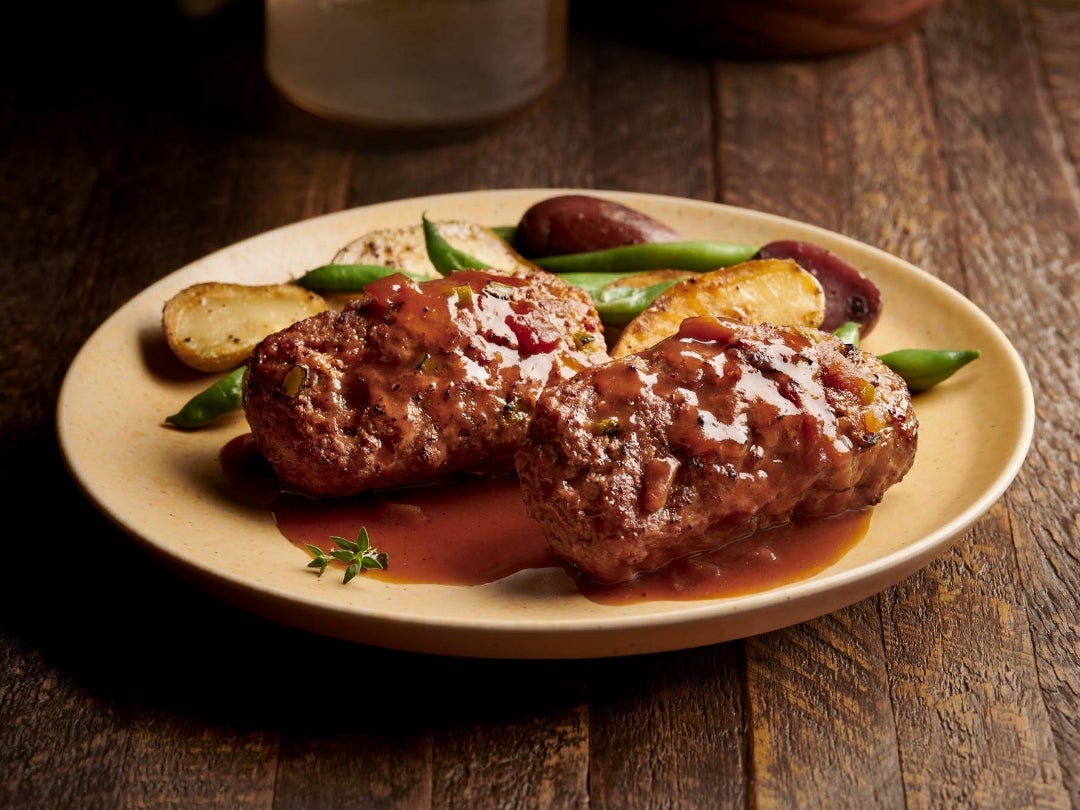 Stouffers Meatloaf with gray on plate with potatoes and vegetables