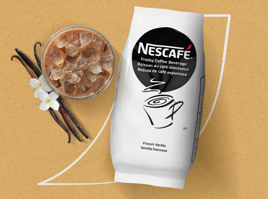 Nescafé French Vanilla Frothy Coffee  Beverage mix packet beside a glass of iced  coffee with vanilla beans and flowers. A  r