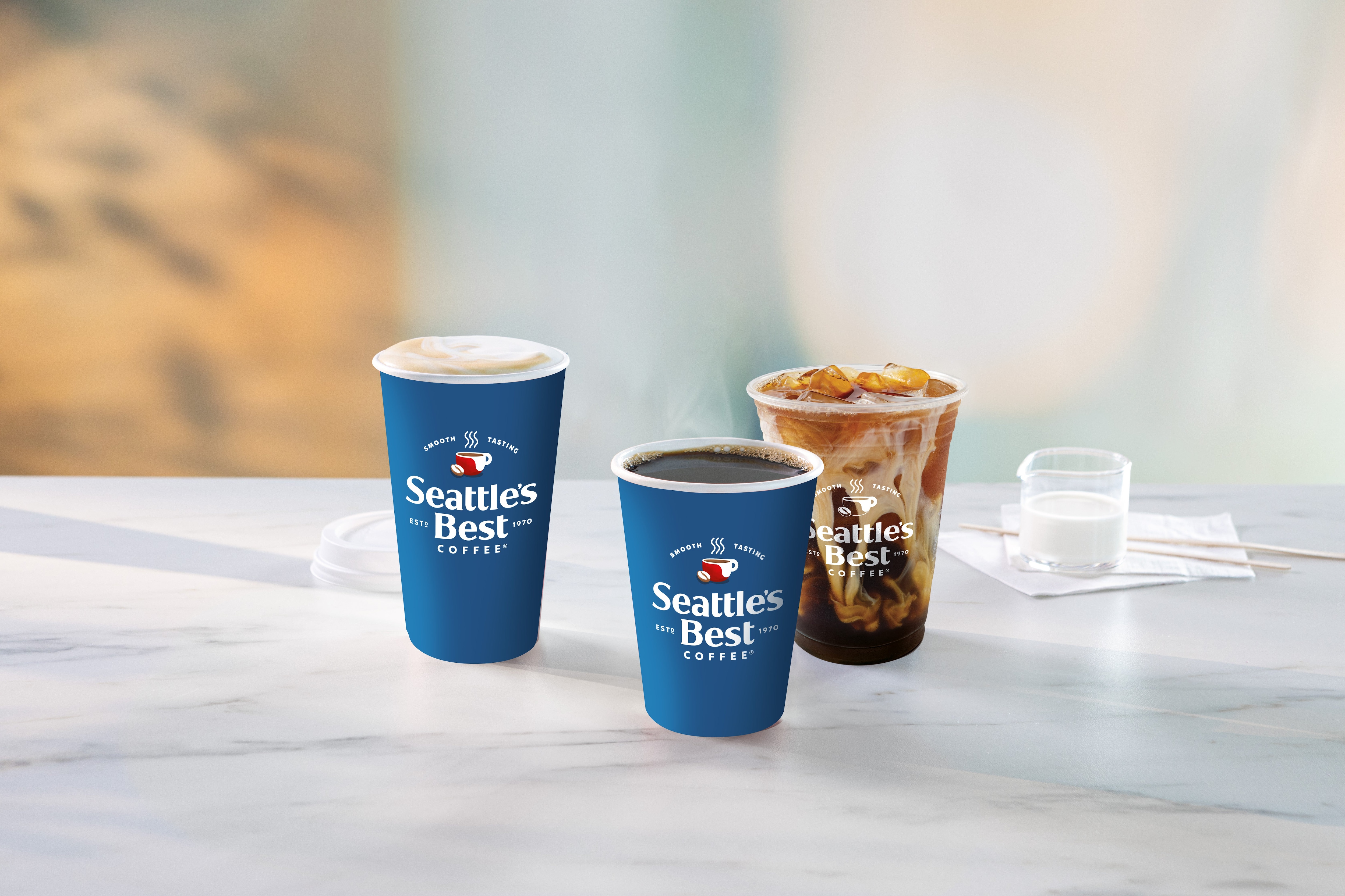 Mix of hot and cold coffee beverages on a table