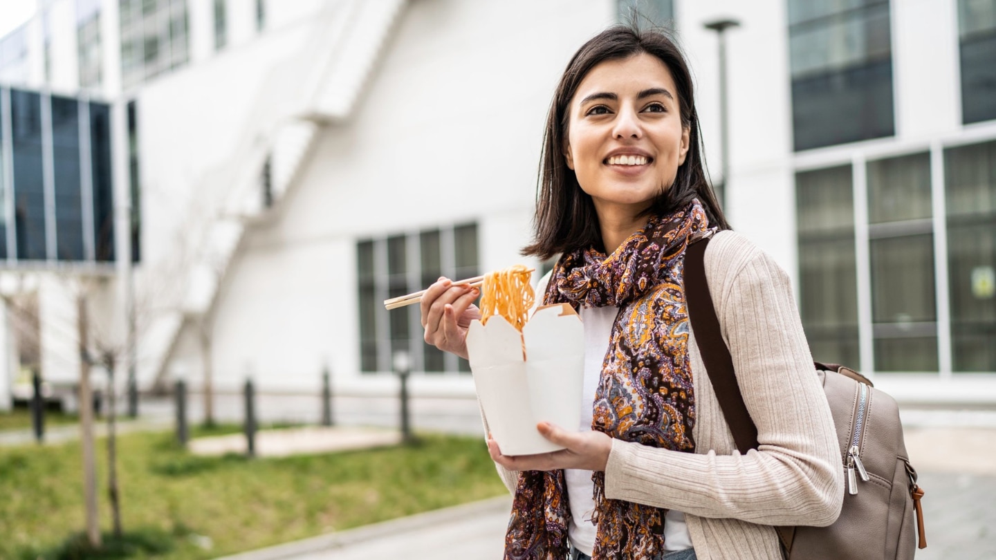 Young woman with takeout container