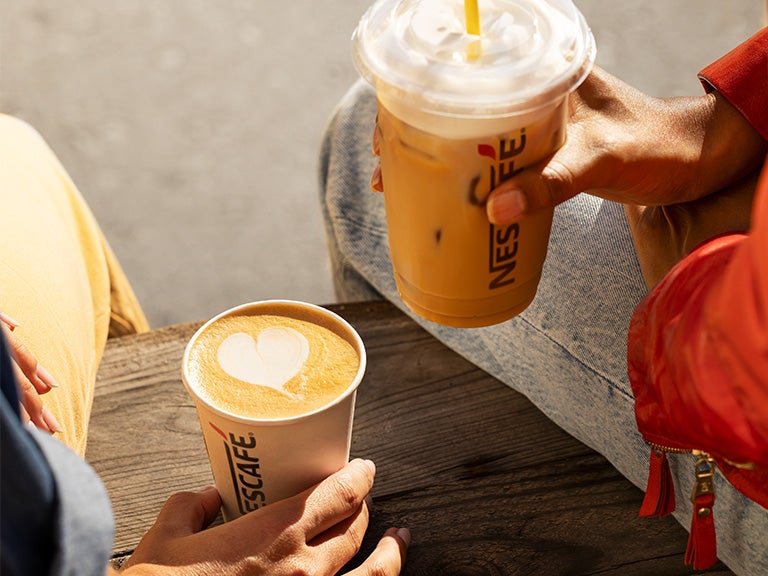 hot and cold cups of coffee in hands