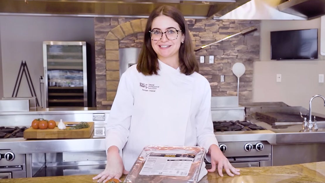 Chef standing with tray of Stouffer's lasagna with meat and sauce