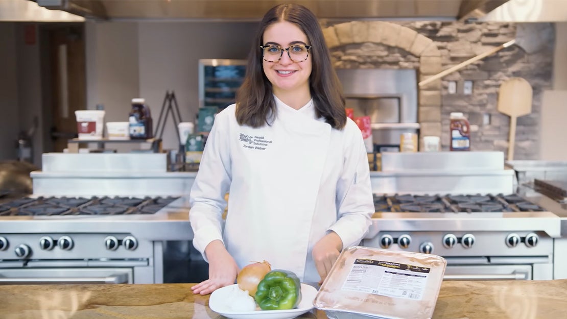 Chef Jordan standing in chef coat with green pepper onion salisbury steak