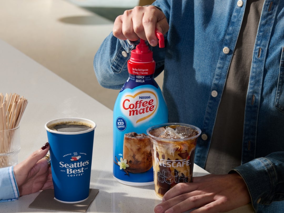 Coffee mate pump bottle being added to iced coffee