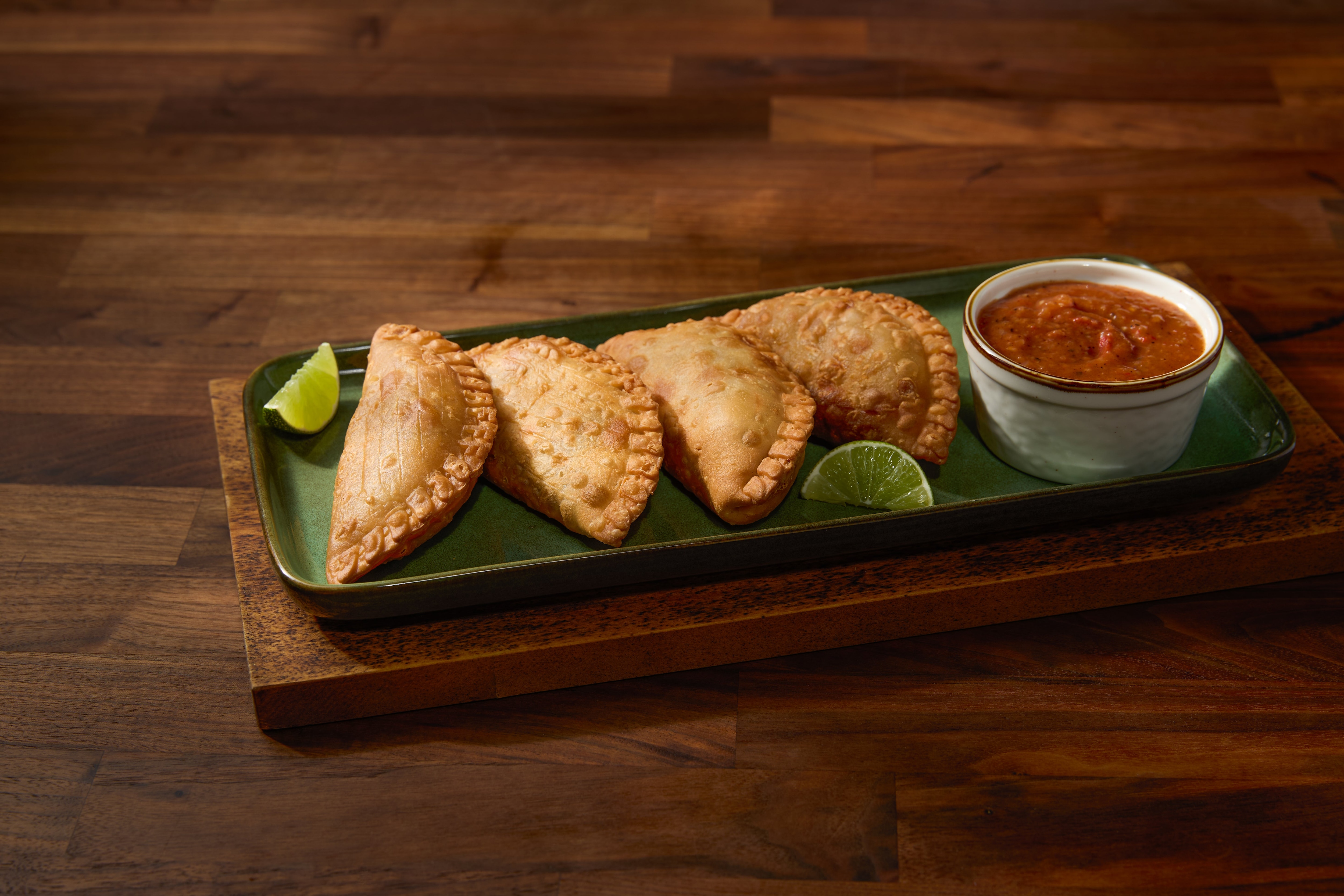 empanadas on wood serving board
