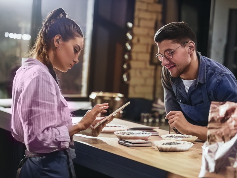 woman using electronic tablet with customer