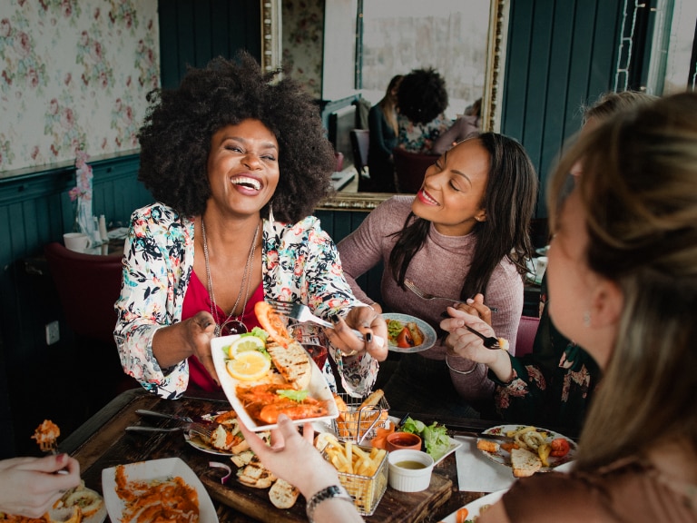 women sharing food at table