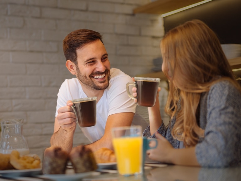 man and woman drinking coffee and juice