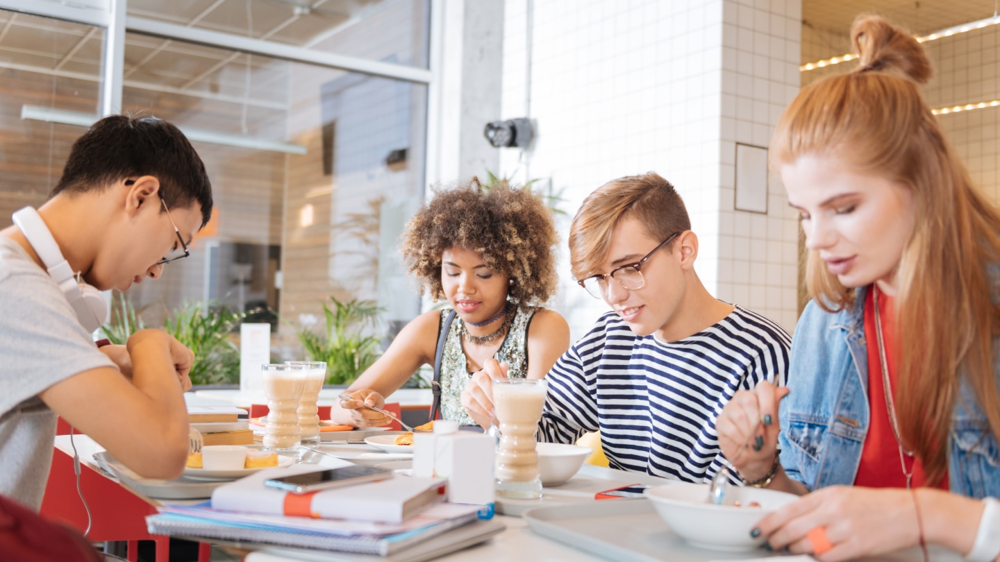 friends eating and drinking together at table