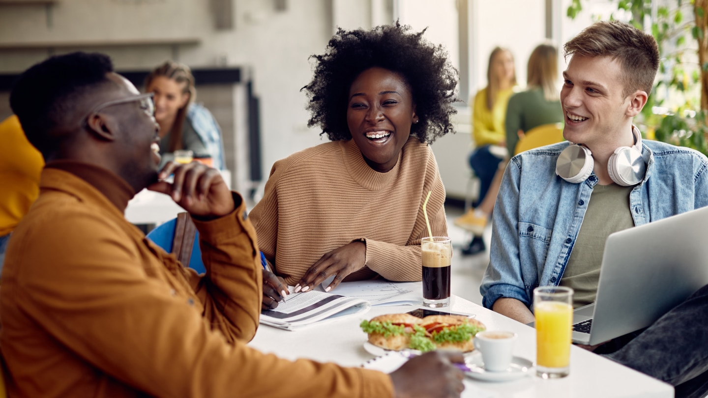 three friends dining out laughing