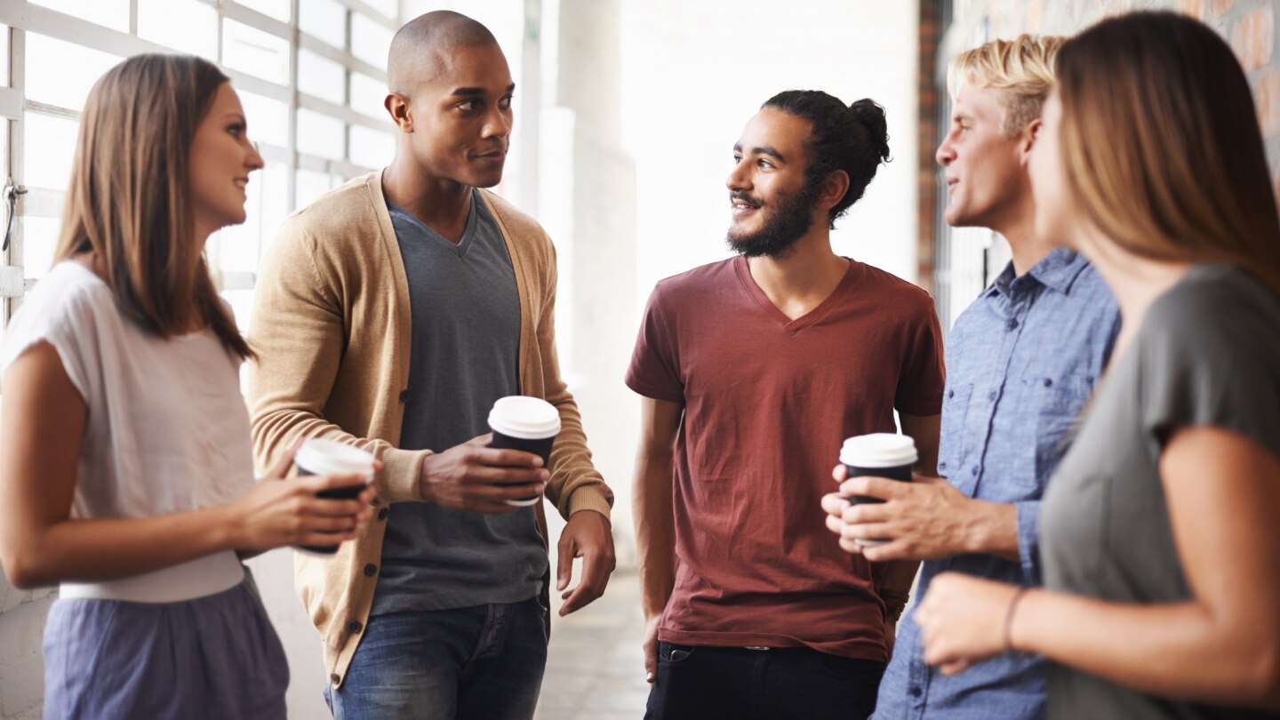 college students talking while drinking coffee