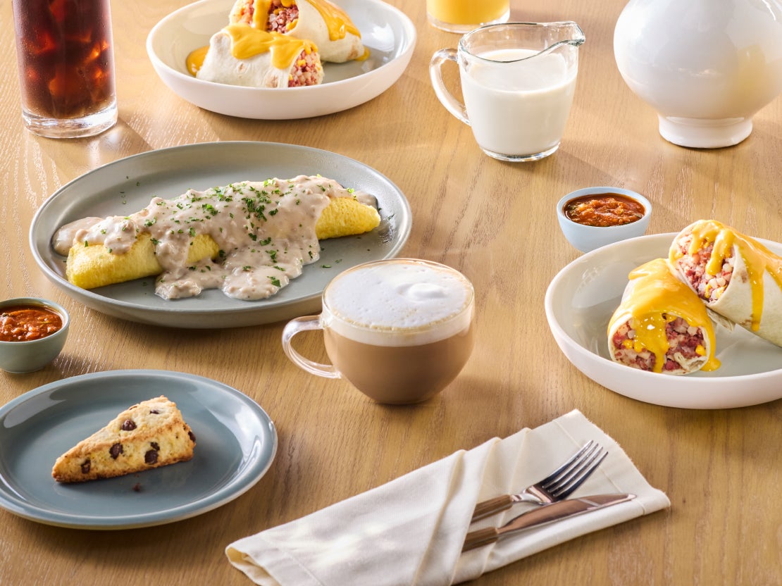 Several plates on a table featuring various sauces