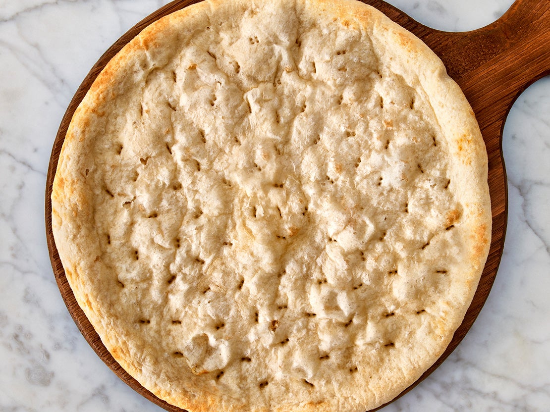 Baked pizza crust on a board