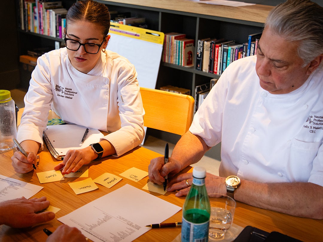 chefs at table writing down information