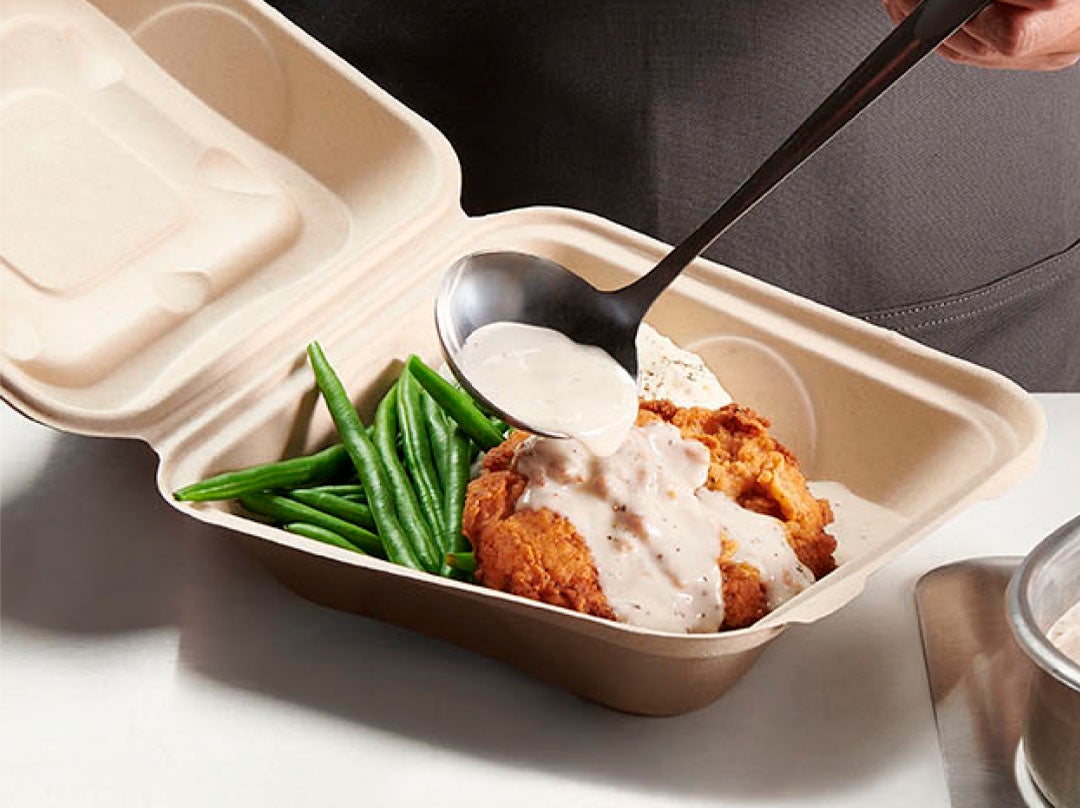 stouffers white gravy pouring over poultry in a to go box