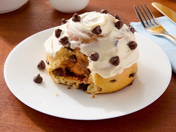 cinnamon roll on plate using Nestle Toll House morsels and Carnation