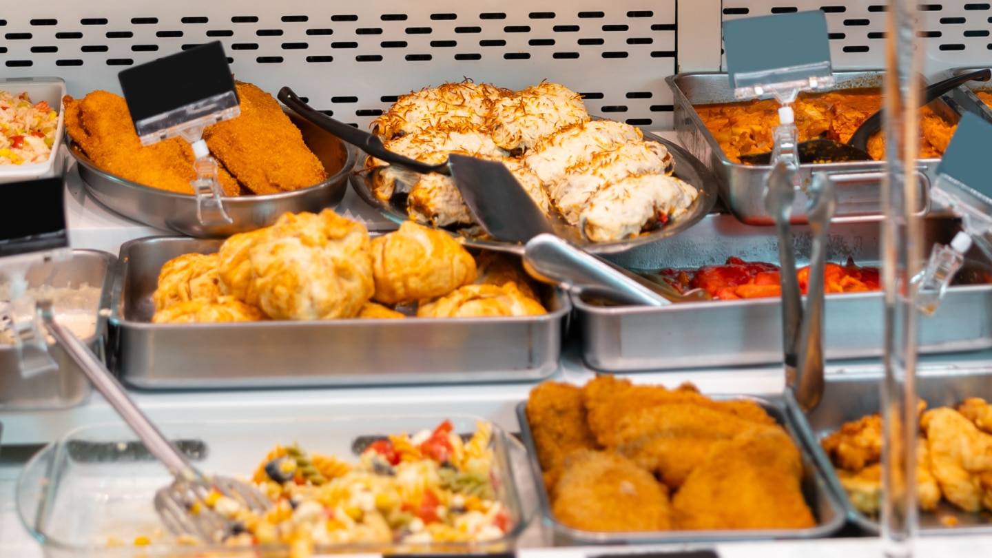 vrepared sandwiches, wraps, and other grab-and-go foods displayed in a refrigerated deli case.