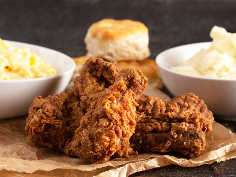 fried chicken and biscuits bowls of mashed potatoes and mac and cheese