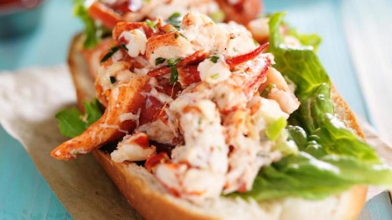 Lobster roll on napkin and wood tabletop